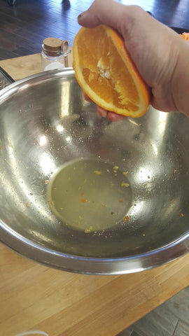 hand squeezing half an orange