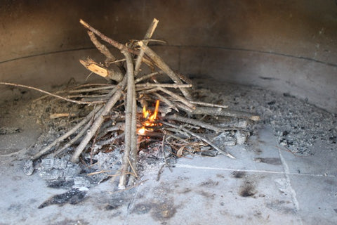 Starting a fire in a wood-fired oven