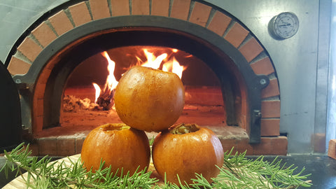 baked mini pumpkins in front of fire
