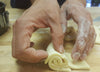 hands rolling up dough