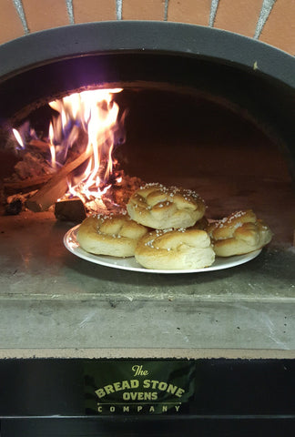 pretzels inside a wood fired oven with flames