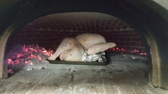 raw turkey in a wood fired oven