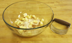 butter flour and oats in a mixing bowl with a pastry blender
